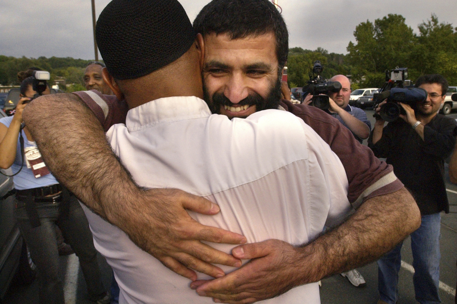 Yassin Aref, facing camera, is greeted by friends and family after he and Mohammed Hossain, not shown, were released from the Rensselaer County Jail after posting bail Wednesday, Aug. 25, 2004, in Troy, N.Y. The two mosque leaders were arrested in Albany in 2004 as part of a fictitious plot to launder money from the sale of a shoulder-fired missile. Convicted in 2006, both men are out of prison and maintain their innocence.