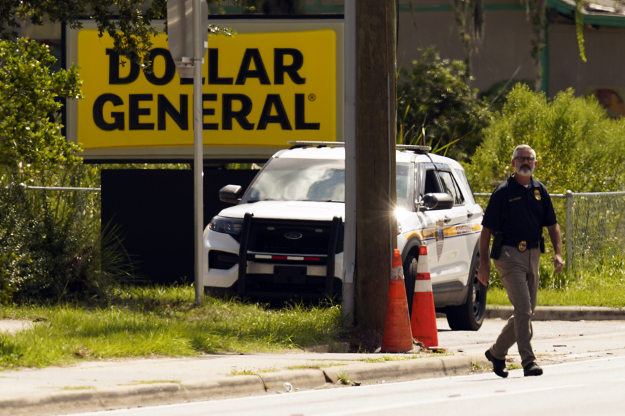 Law enforcement officials continue their investigation at a Dollar General Store that was the scene of a mass shooting, Sunday, Aug. 27, 2023, in Jacksonville, Fla.