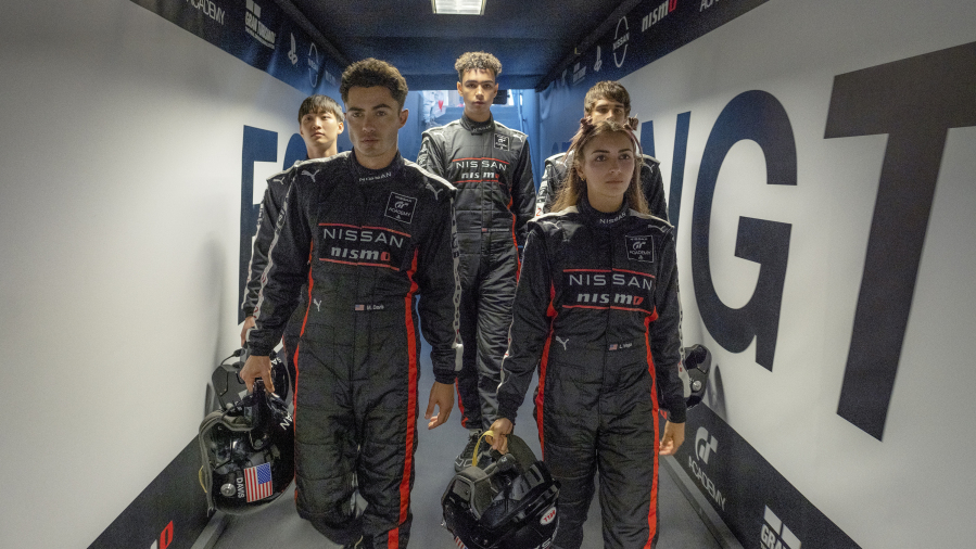 This image released by Columbia Pictures shows, from left, Sang Heon Lee, Darren Barnet, Archie Madekwe, Emelia Hartford and Pepe Barroso Silva  in a scene from "Gran Turismo." (Gordon Timpen/Columbia Pictures/Sony Entertainment via AP)