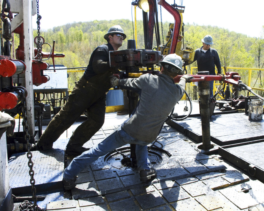 FILE - Workers move a section of well casing into place at a Chesapeake Energy natural gas well site near Burlington, Pa., in Bradford County, on April 23, 2010. A team of that has spent four years studying the health effects of natural gas fracking in southwestern Pennsylvania is set to present its findings Tuesday, Aug. 15, 2023.