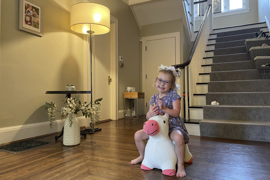 Brynn Schulte rides on a toy unicorn at her home in Cincinnati shortly before getting medication to treat her rare genetic bleeding disorder, Aug. 3, 2023. Brynn was diagnosed thanks to whole genome testing, which was recently shown to be nearly twice as good at finding genetic disorders in sick babies as more targeted tests. Her parents and doctors credit early diagnosis with saving her life.