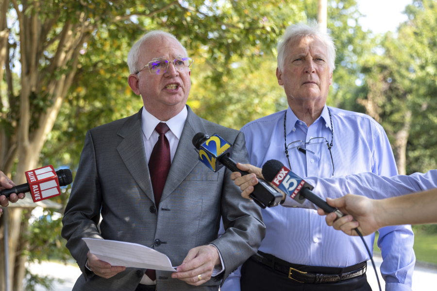 John Eastman, left, an attorney indicted with former President Donald Trump, makes a statement to press alongside his attorney, David Wolfe, outside the Fulton County Jail in Atlanta, where he was booked on Tuesday, Aug. 22, 2023.
