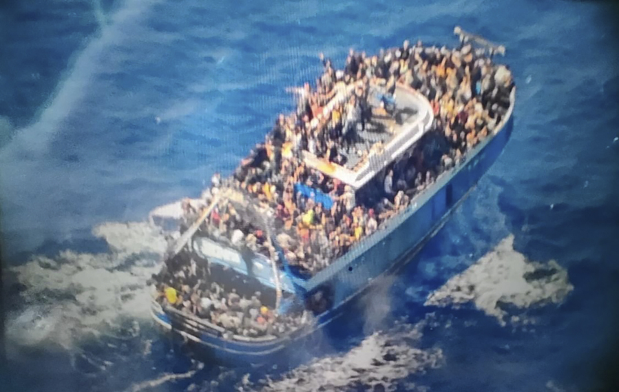 FILE - This undated handout image provided by Greece's coast guard on June 14, 2023, shows scores of people on a battered fishing boat that later capsized and sank off southern Greece. Nearly two months after a dilapidated fishing trawler crammed with people heading from Libya to Italy sank in the central Mediterranean, killing hundreds, relatives are still frantically searching for their loved ones among the missing and the dead.