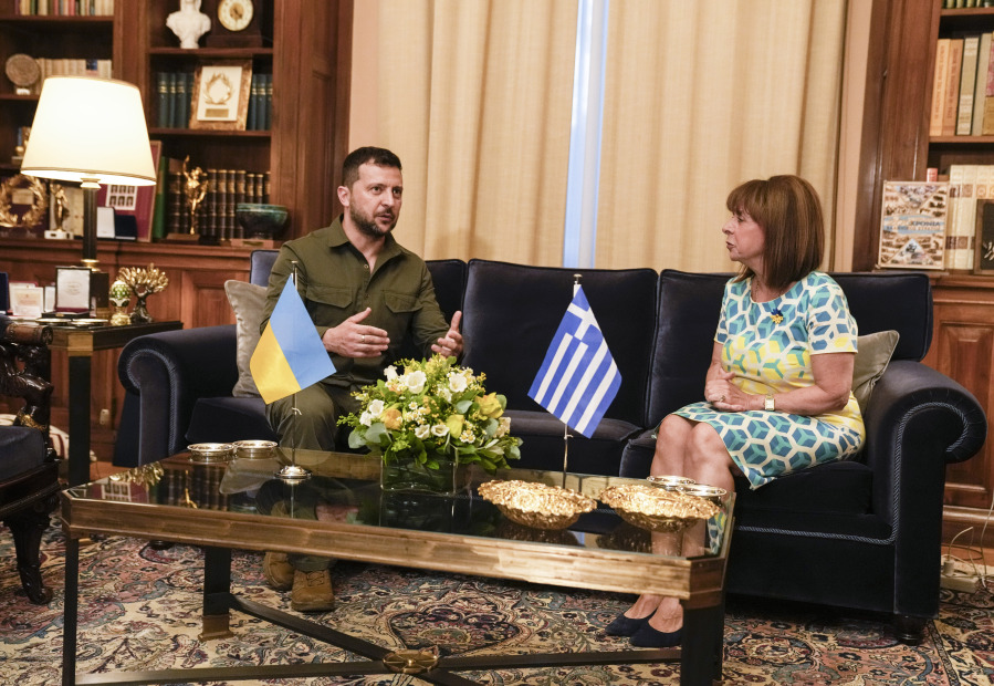 Greek President Katerina Sakellaropoulou, right, listens Ukraine's President Volodymyr Zelenskyy during their meeting in Athens, Monday, Aug. 21, 2023. Zelenskyy flew to Greece Monday for talks with the country's leadership and to attend an informal meeting of Balkan leaders with top European Union officials.