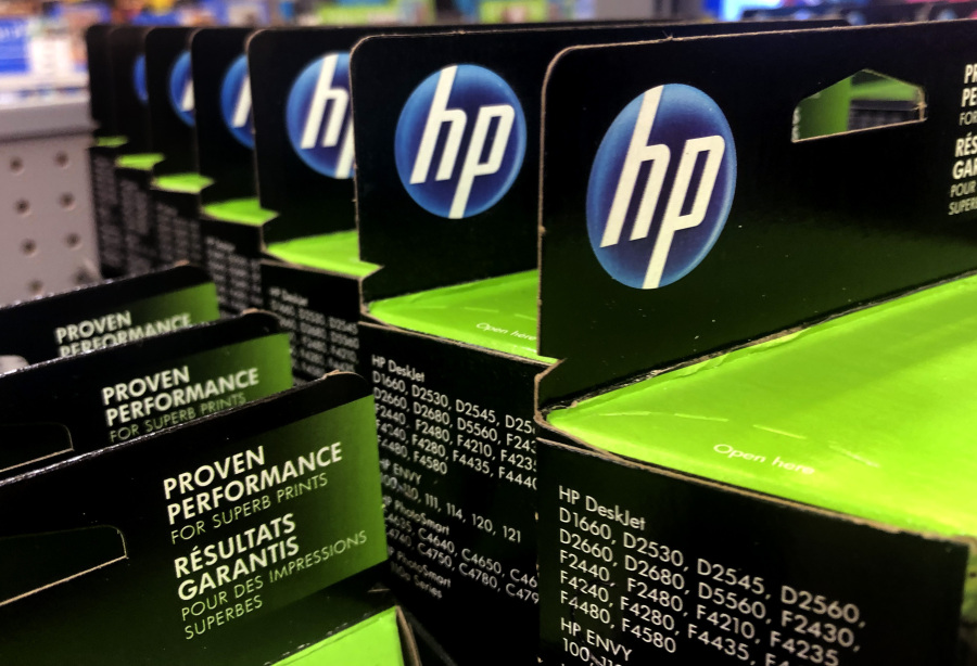 FILE - This Aug. 15, 2019, photo shows the HP logo on Hewlett-Packard printer ink cartridges at a store in Manchester, N.H. HP Inc. has failed to shunt aside claims in a lawsuit that it disables scanners and other functions on its multifunction printers whenever the ink runs low. The suit claims that HP's so-called "all-in-one" printers provide consumers no indication the devices require printer ink to scan documents or send faxes.