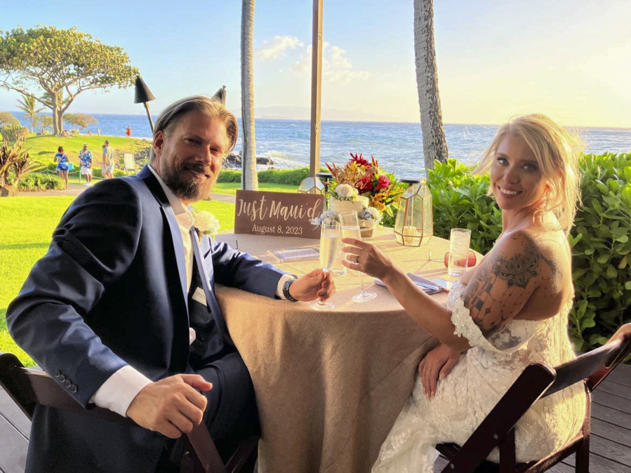 Bob and Cindy Curler pose at their wedding Tuesday at the Wailea Beach Resort in Lahaina on Maui, Hawaii. The Pittsburgh couple spent their wedding night in a garage as wildfires tore through  the town.