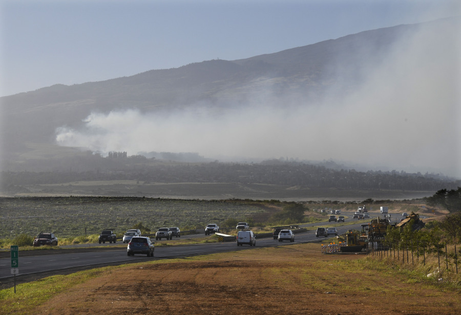 Smoke blows across the slope of Haleakala volcano on Maui, Hawaii, as a fire burns in Maui's upcountry region on Tuesday, Aug. 8. 2023. Several Hawaii communities were forced to evacuate from wildfires that destroyed at least two homes as of Tuesday as a dry season mixed with strong wind gusts made for dangerous fire conditions.