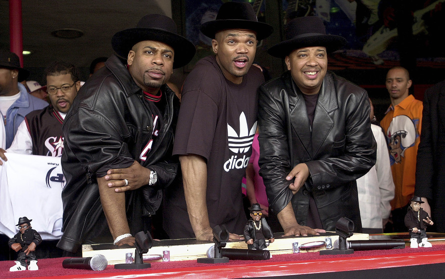 Hip-hop pioneers RUN-DMC create handprints in cement as they are inducted into Hollywood's RockWalk, Feb. 25, 2002, in Los Angeles. Adidas signed the rap group to a $1 million deal that resulted in their own shoe line in 1988.