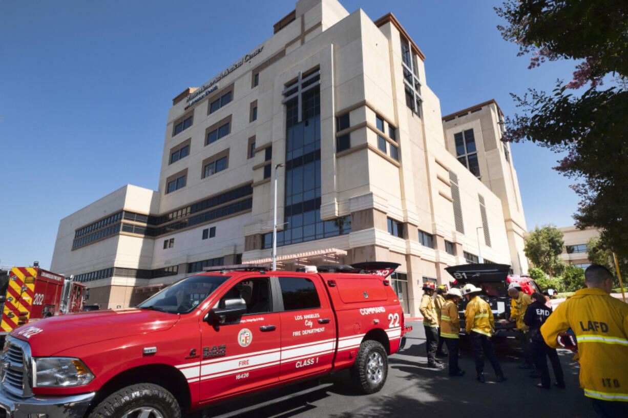 Los Angeles Fire Department personnel gather at the Adventist Health White Memorial Medical Center in Los Angeles on Tuesday, Aug. 22, 2023. A succession of power outages at a Los Angeles hospital prompted the evacuation of 28 patients in critical condition to other hospitals early Tuesday, while 213 other patients were moved to another building in the medical center, authorities said.