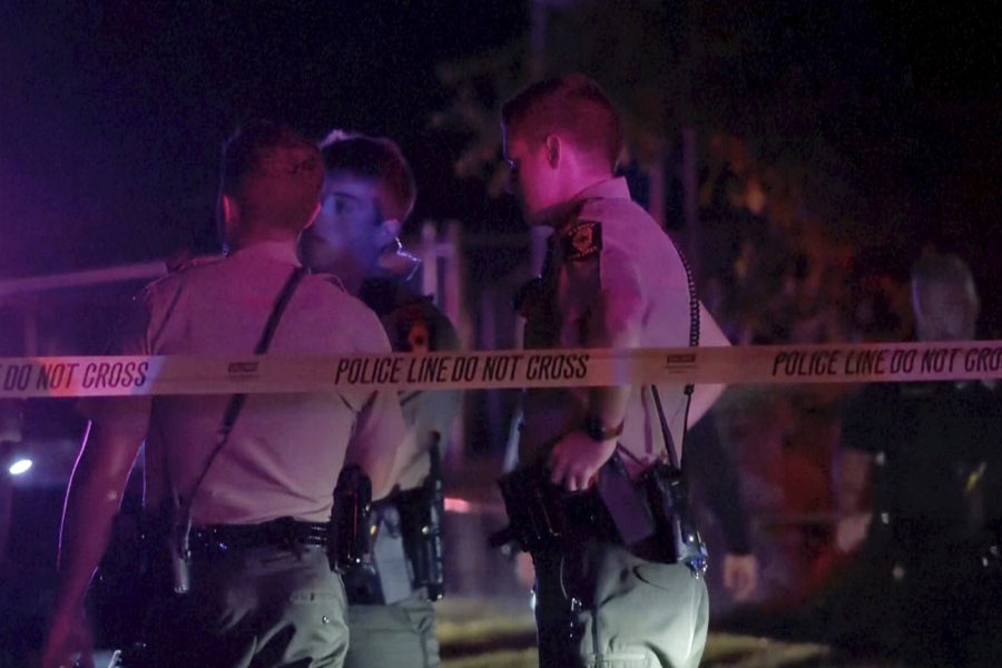 Law enforcement agents respond to the scene of a shooting late Wednesday, Aug. 30, 2023 in Peoria, Ill.  Several people were shot and two of them were in critical condition, police said.