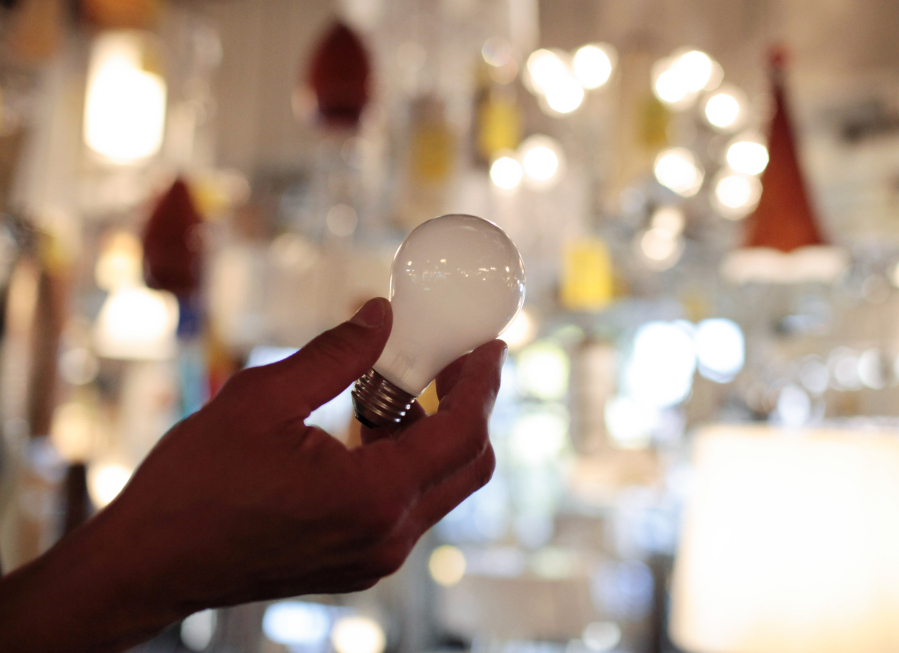 FILE - Manager Nick Reynoza holds a 100-watt incandescent light bulb at Royal Lighting in Los Angeles, Jan. 21, 2011. New federal rules governing the energy efficiency of lighting systems went into full effect Tuesday, effectively ending the sale and manufacture of bulbs that trace their origin to an 1880 Thomas Edison patent. (AP Photo/Jae C.