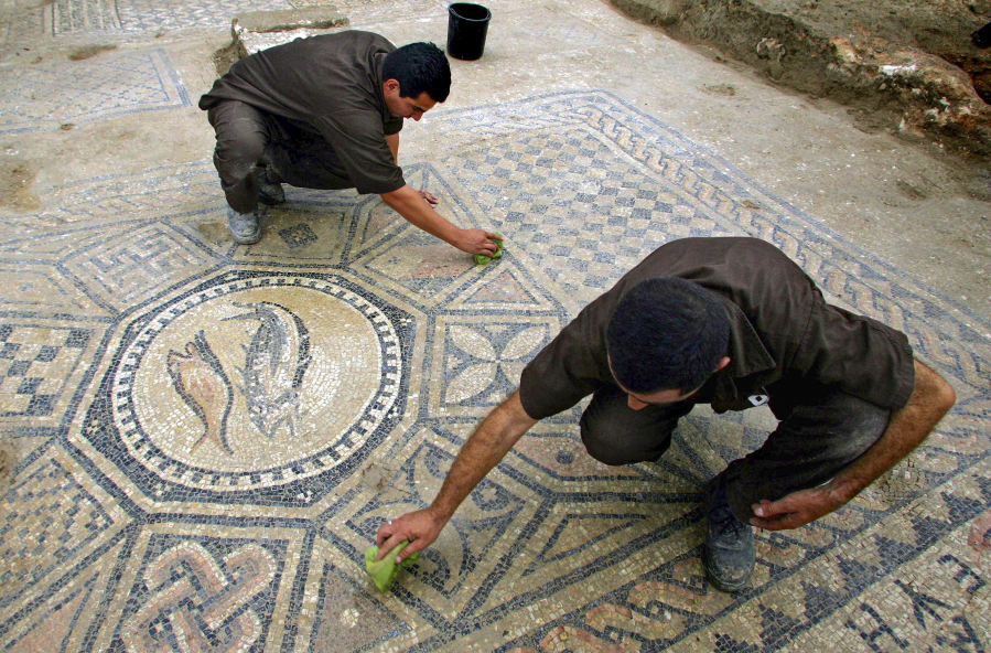 Prisoners work on a nearly 1,800-year-old decorated floor from an early Christian prayer hall discovered by Israeli archaeologists on Nov. 6, 2005, in the Megiddo prison in Tel Megiddo, Israel. Israeli officials are considering uprooting the mosaic and loaning it to the controversial Museum of the Bible in Washington, D.C.