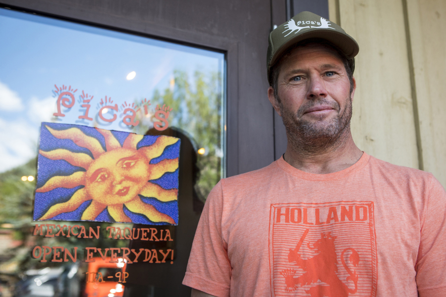 Pica's Mexican Taqueria co-owner Andy Parazette poses for a portrait in front of his business in Jackson, WY. , on Aug. 23, 2023. At the height of the post-pandemic economic recovery, Parazette's shop saw such a crush of business that customers sometimes had to wait an hour for a burrito. This year, business is still good but has cooled, Parazette said, though other restaurants more dependent on tourism have experienced steeper drops.
