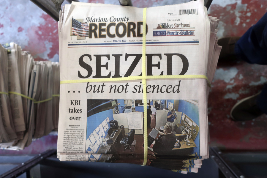 A stack of the latest weekly edition of the Marion County Record sits in the back of the newspaper's building, awaiting unbundling, sorting and distribution, Wednesday, Aug. 16, 2023, in Marion, Kan. The newspaper's front page was dedicated to two stories about a raid by local police on its offices and the publisher's home on Aug. 11, 2023.