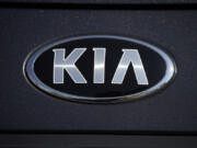 FILE - The company logo shines off the hood of a 2021 K5 sedan on display in the Kia exhibit at the Denver auto show Friday, Sept. 17, 2021, at Elitch's Gardens in downtown Denver.  Kia is recalling about 320,000 cars in the U.S. to fix a problem that could stop the trunk from being opened from the inside, Thursday, Aug. 31, 2023. The recall covers the Optima midsize car from 2016 through 2018, Optima hybrids and plug-ins from 2017 and 2018, and the Rio small car from 2016 and 2017.