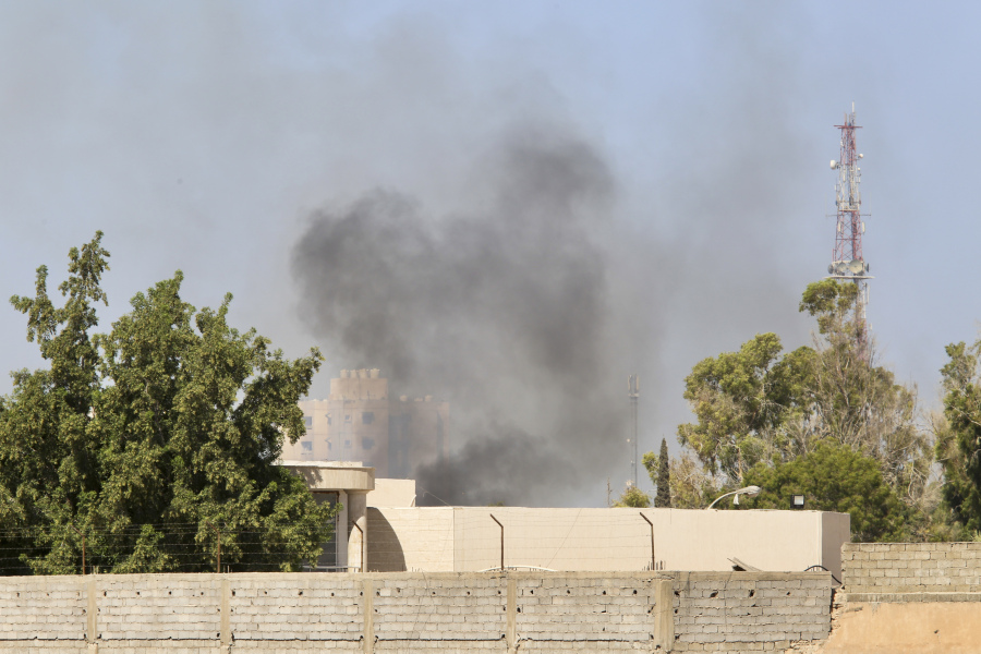 Smoke rises during clashes between rival militias in Tripoli, Libya, Tuesday, Aug. 15, 2023. According to local media, fighting broke out between the 444 brigade and the Special Deterrence Force late Monday evening.