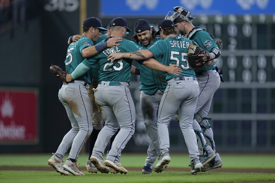 The Seattle Mariners infielders dance after a baseball game against the Houston Astros, Sunday, Aug. 20, 2023, in Houston. (AP Photo/Kevin M.