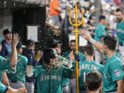Seattle Mariners' Josh Rojas is doused with pumpkin seeds in the dugout after his two-run home run off Chicago White Sox starting pitcher Mike Clevinger during the fourth inning of a baseball game Tuesday, Aug. 22, 2023, in Chicago.