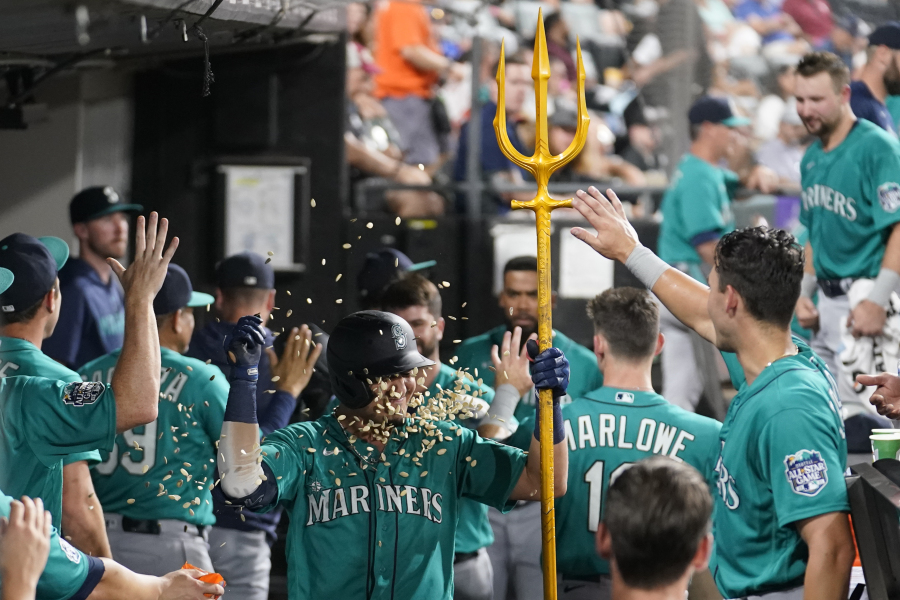 Seattle Mariners' Josh Rojas is doused with pumpkin seeds in the dugout after his two-run home run off Chicago White Sox starting pitcher Mike Clevinger during the fourth inning of a baseball game Tuesday, Aug. 22, 2023, in Chicago.