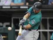 Seattle Mariners' Cal Raleigh hits a two-run double during the first inning of a baseball game against the Chicago White Sox in Chicago, Monday, Aug. 21, 2023. (AP Photo/Nam Y.