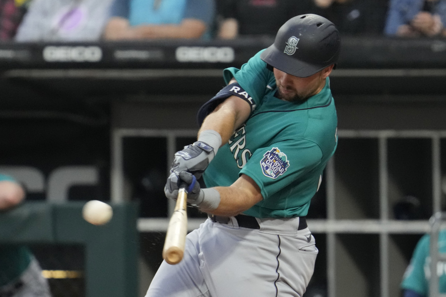 Seattle Mariners' Cal Raleigh hits a two-run double during the first inning of a baseball game against the Chicago White Sox in Chicago, Monday, Aug. 21, 2023. (AP Photo/Nam Y.