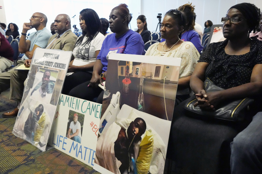 The families of Michael Corey Jenkins and Damien Cameron sit together during the Justice Department's Civil Rights Division tour Thursday, June 1, 2023, in during a Jackson, Miss. Six white former law enforcement officers in Mississippi who called themselves the "Goon Squad" pleaded guilty Thursday, Aug. 3, 2023, to a racist assault on the two Black men in a home raid that ended with an officer shooting one man in the mouth. (AP Photo/Rogelio V.