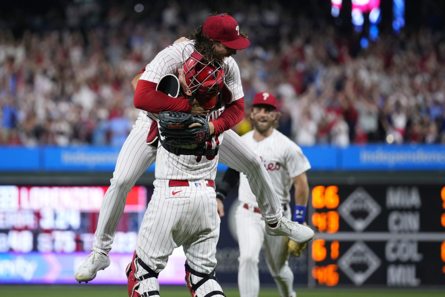 Philadelphia Phillies pitcher Michael Lorenzen, left, and J.T. Realmuto celebrate after Lorenzen's no-hitter during a baseball game against the Washington Nationals, Wednesday, Aug. 9, 2023, in Philadelphia.