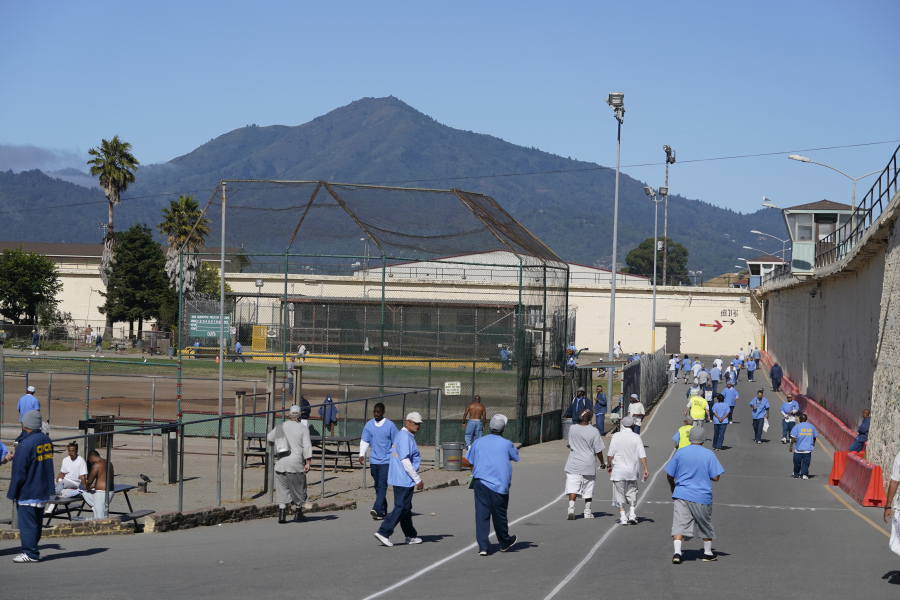 Incarcerated men are seen in the recreation yard with Mt. Tamalpais in the background during a media tour at San Quentin State Prison in San Quentin, Calif., on July 26, 2023. California Gov. Gavin Newsom has ambitious and expensive plans for a dilapidated factory at San Quentin State Prison where inmates of one of the nation's most notorious lockups once built furniture. He wants to spend $360 million demolishing the building and replacing it with one more reminiscent of a college campus, with a student union, classrooms and possibly a coffee shop.