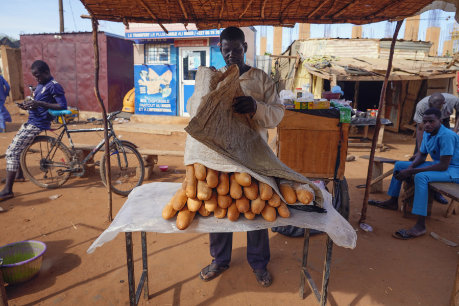 A man sells baguettes in Niamey, Niger, Friday, Aug. 11, 2023. The ECOWAS bloc said it had directed a "standby force" to restore constitutional order in Niger after its deadline to reinstate ousted President Mohamed Bazoum expired.