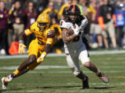 FILE - Oregon State running back Damien Martinez (6) runs past Arizona State defensive back Chris Edmonds (5) during the first half of an NCAA college football game in Tempe, Ariz., Saturday, Nov. 19, 2022. Oregon State opens their season at San Jose State on Sept. 3. (AP Photo/Ross D.