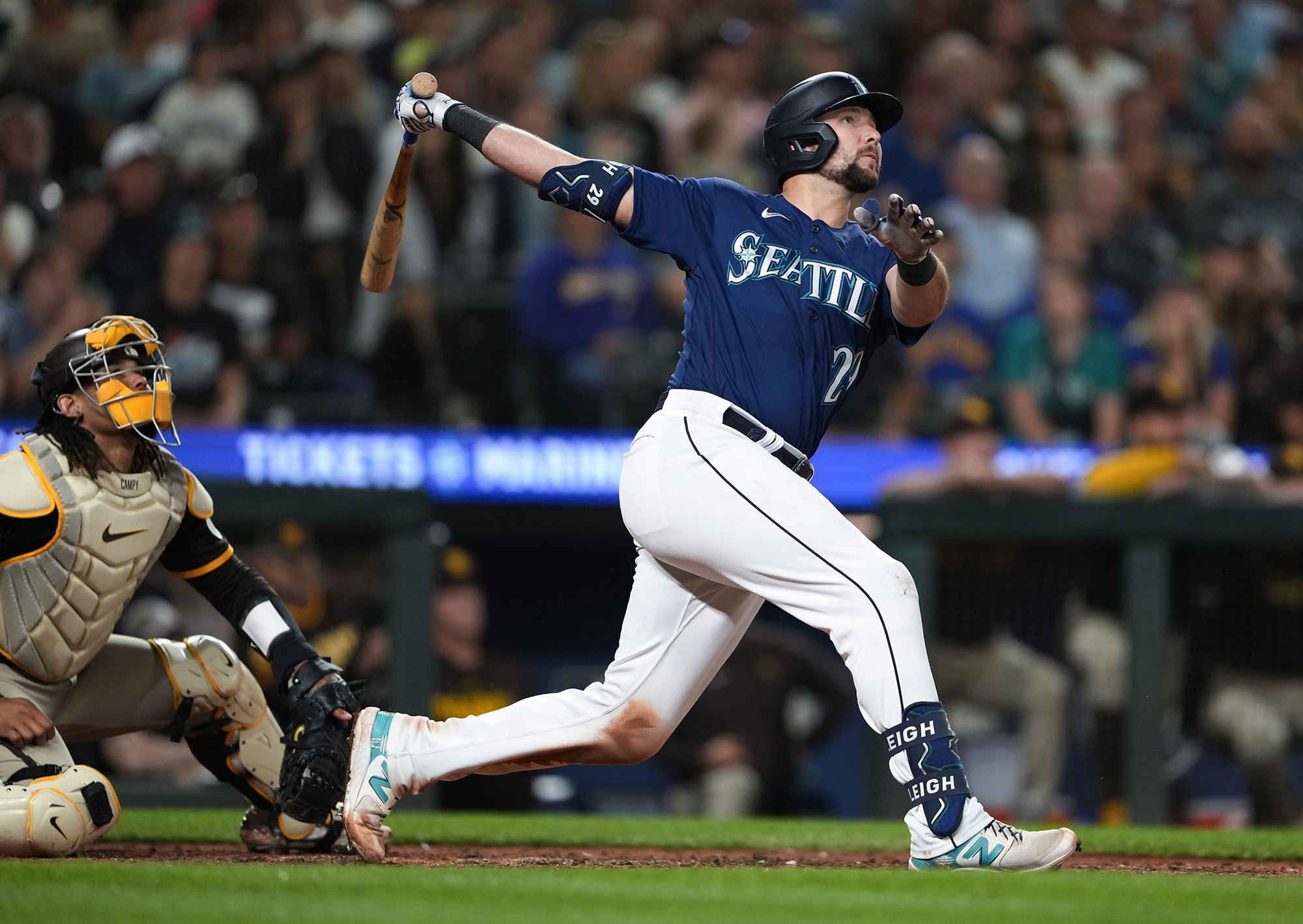 Seattle Mariners' Cal Raleigh watches his two-run home run next to San Diego Padres catcher Luis Campusano during the eighth inning of a baseball game Wednesday, Aug. 9, 2023, in Seattle.