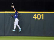 Seattle Mariners center fielder Julio Rodriguez catches a fly ball from San Diego Padres' Fernando Tatis Jr. during the fourth inning of a baseball game Tuesday, Aug. 8, 2023, in Seattle.