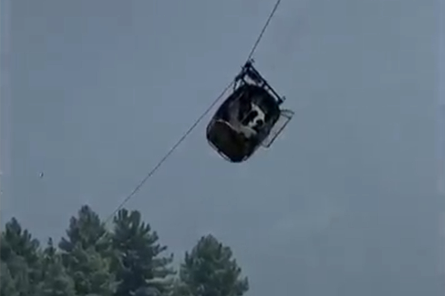 In this image taken from video, a cable car carrying six children and two adults dangles hundreds of meters above the ground in the remote Battagram district, Khyber Pakhtunkhwa, Pakistan on Tuesday, Aug. 22, 2023. The cable car malfunctioned, trapping the occupants for hours before rescuers arrived in helicopters to try to free them.