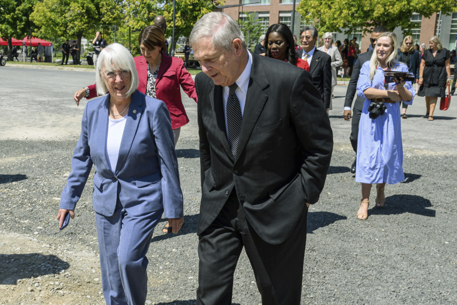 In this photo provided by Washington State University, U.S. Sen. Patty Murray, D-Wash., left, walks with U.S. Secretary of Agriculture Tom Vilsack, center, Tuesday, Aug. 1, 2023, before they took part in the ceremonial groundbreaking for a new USDA research facility at Washington State University in Pullman, Wash.