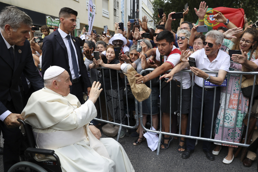 Pope Francis waves to the crowd as he arrives for a meeting with the Portugal's Prime Minister Antonio Costa in Lisbon, Wednesday, Aug. 2, 2023. Pope Francis arrived Wednesday in Lisbon to attend the international World Youth Day on Sunday that is expected to bring hundreds of thousands of young Catholic faithful to Portugal. (Miguel A.
