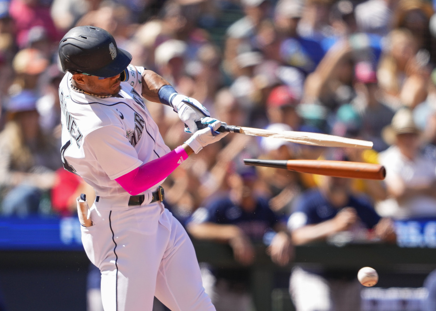 Seattle Mariners' Julio Rodriguez breaks his bat on an RBI single against the Boston Red Sox to score Tom Murphy during the seventh inning of a baseball game, Wednesday, Aug. 2, 2023, in Seattle.