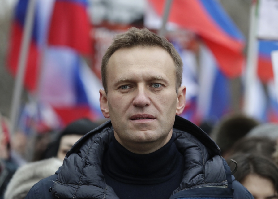 FILE - In this Sunday, Feb. 24, 2019 file photo, Russian opposition activist Alexei Navalny takes part in a march in memory of opposition leader Boris Nemtsov in Moscow, Russia. In August 2020, the opposition leader fell ill on a flight from Siberia to Moscow. The plane landed in the city of Omsk, where Navalny was hospitalized in a coma. Two days later, he was airlifted to Berlin, where he recovered.