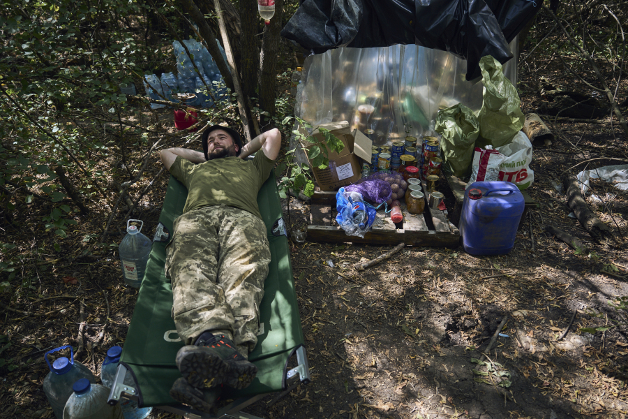 A Ukrainian soldier rests at his position on the frontline in Donetsk region, Ukraine, Wednesday, Aug. 9, 2023.