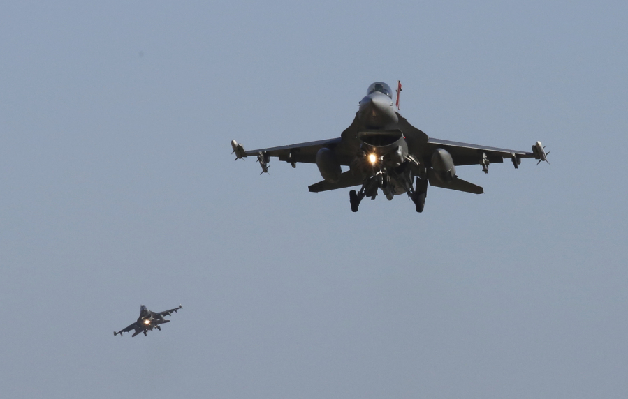 FILE - U.S. Air Force F-16 fighter jets fly over the Osan U.S. Air Base during a combined air force exercise with the United States and South Korea in Pyeongtaek, South Korea, Dec. 4, 2017. The U.S. has once again buckled under pressure from European allies and Ukraine's leaders and agreed to provide more sophisticated weapons to the war effort. This time it's all about F-16 fighter jets.