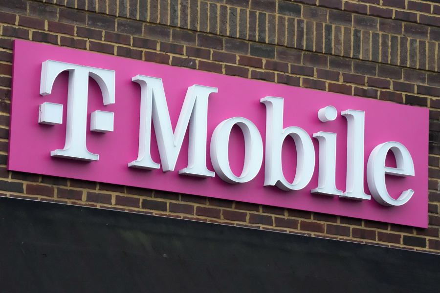FILE - The sign for a T-Mobile store is seen, Jan. 30, 2023, in Pittsburgh. T-Mobile plans to cut 5,000 jobs, or about 7% of its workforce, the U.S. wireless carrier announced Thursday, Aug. 24. (AP Photo/Gene J.