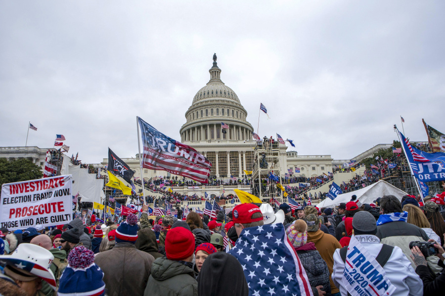 FILE - Rioters loyal to President Donald Trump rally at the U.S. Capitol in Washington on Jan. 6, 2021.