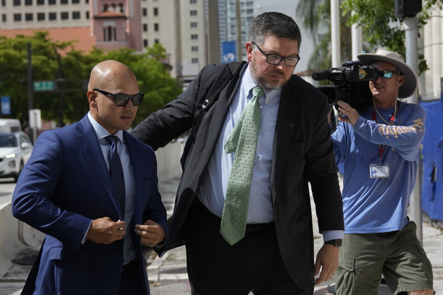 Walt Nauta, left, a valet to former President Donald Trump who is charged with helping the ex-president hide classified documents the Justice Department wanted back, arrives for his arraignment along with defense attorney Stanley Woodward, at the James Lawrence King Federal Justice Building in Miami, Thursday, July 6, 2023.