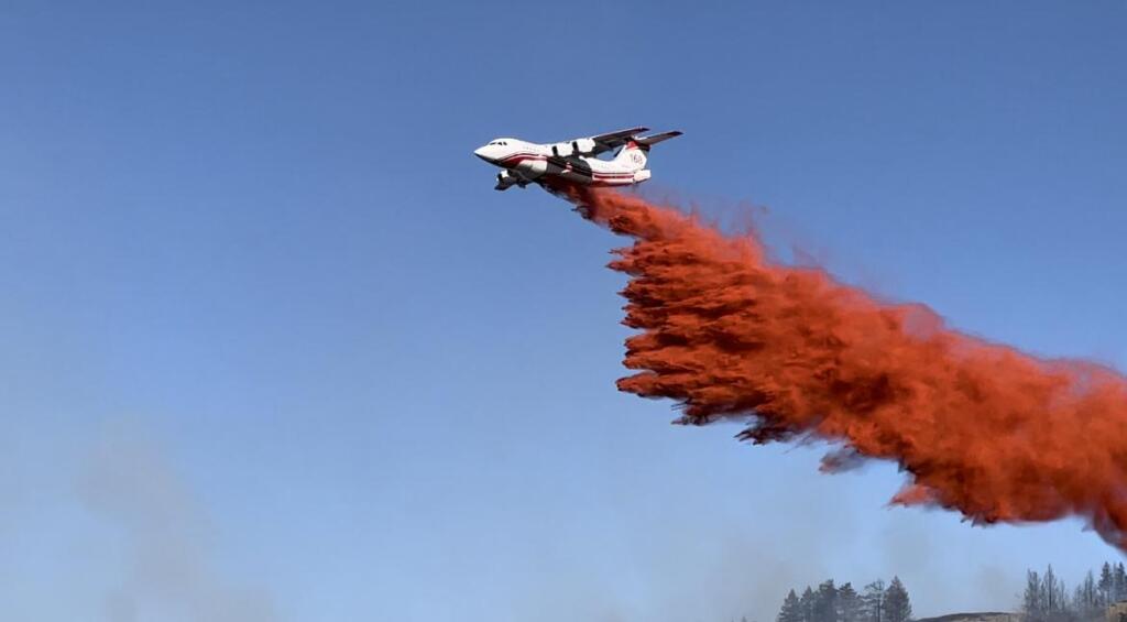 A Very Large Air Tanker drops fire retardant on the southwest flank of the Eagle Bluff Fire near the Canadian border on Aug. 5.