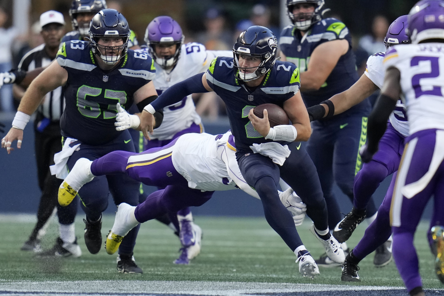 Seattle Seahawks quarterback Drew Lock (2) runs against the Minnesota Vikings during the first half of an NFL preseason football game in Seattle, Thursday, Aug. 10, 2023.