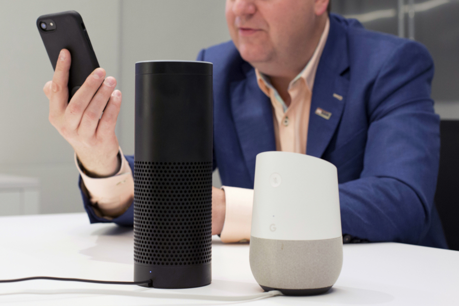 A man holds an iPhone next to an Amazon Echo, center, and a Google Home, right, in New York on June 14, 2018. A study published Monday, Aug. 28, 2023, in JAMA Network Open, says Alexa, Siri and other voice assistants could do a better job giving instructions on CPR to help bystanders respond in emergencies.