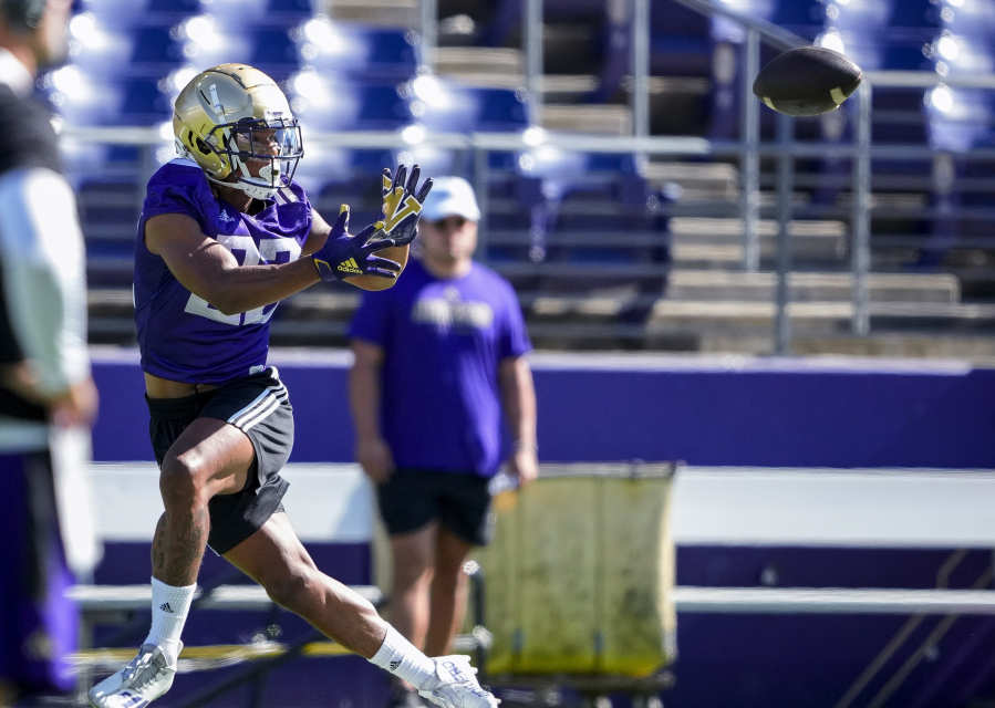 Washington running back Cameron Davis jumps to catch the ball during the NCAA college football team's practice Wednesday, Aug. 2, 2023, in Seattle.