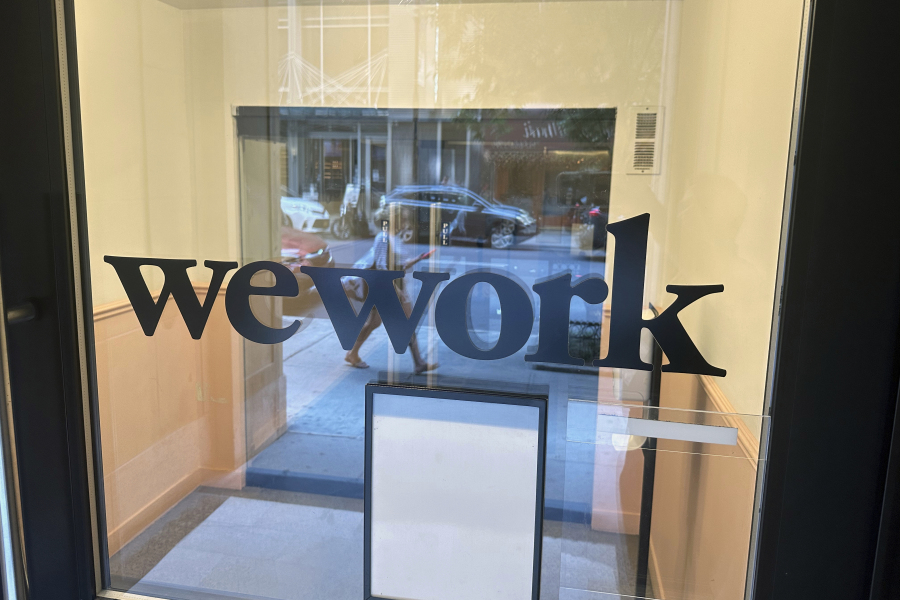 FILE - A sign for WeWork is displayed at the workspace-sharing office in the borough of Manhattan in New York, Aug. 9, 2023. WeWork said on Tuesday, Aug. 8, that there was "substantial doubt" on its ability to stay in business, prompting speculation around the future of the troubled workspace-sharing company.