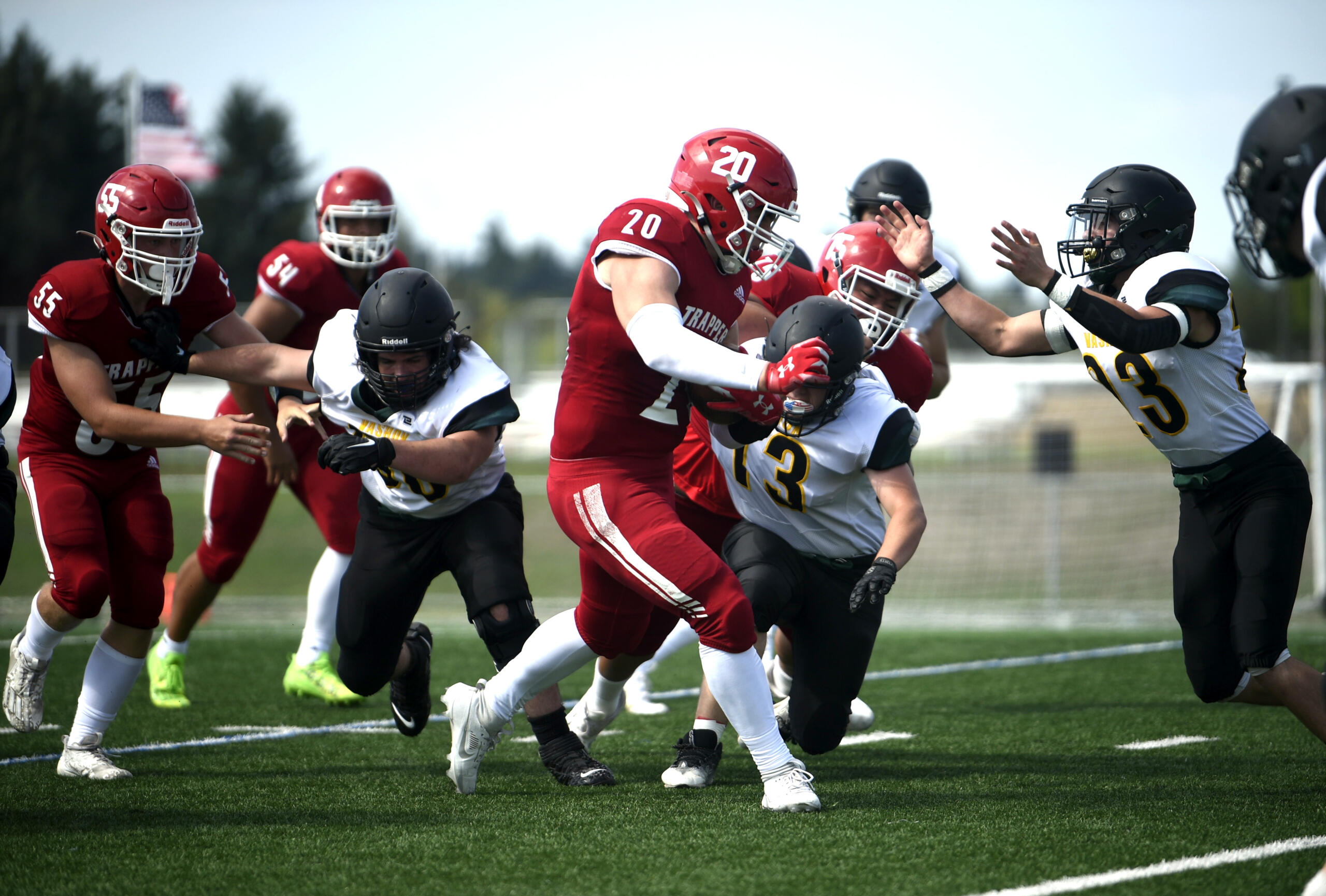 Fort Vancouver junior Denis Zayets runs ahead for extra yards against Vashon Island defenders on Saturday, Sept. 2, 2023, at Fort Vancouver High School.