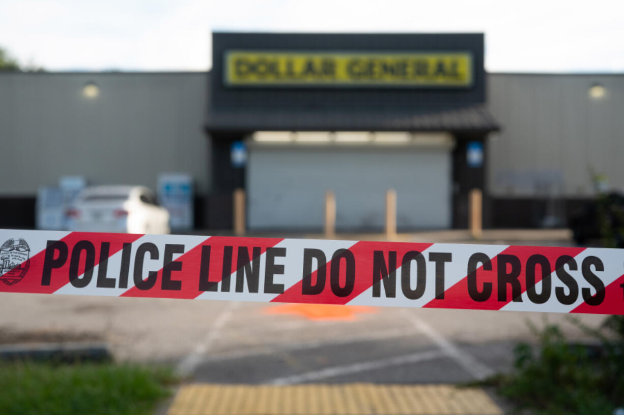 Crime scene tape stretches across the property of a Dollar General store where three people were shot and killed two days earlier on Aug. 28, 2023, in Jacksonville, Florida. According to law enforcement, the shooter targeted the three Black victims because of their race.