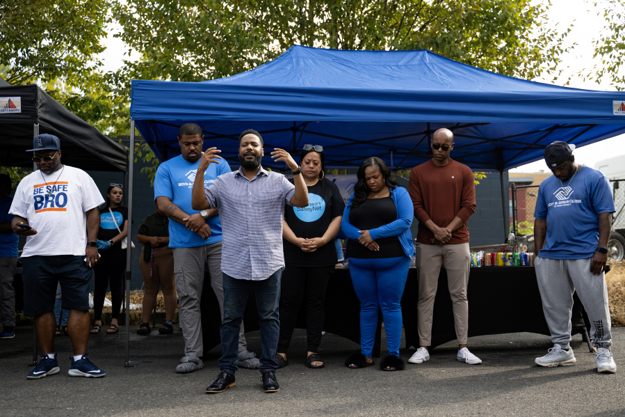 Pastor Otis Brown, from Holly Park Community Church, speaks to the crowd Friday, Aug. 25, 2023, at the Safeway on Rainier Avenue South in Seattle. This is the first time in a month the group has met following a shooting that injured two staff members and wounded three others.